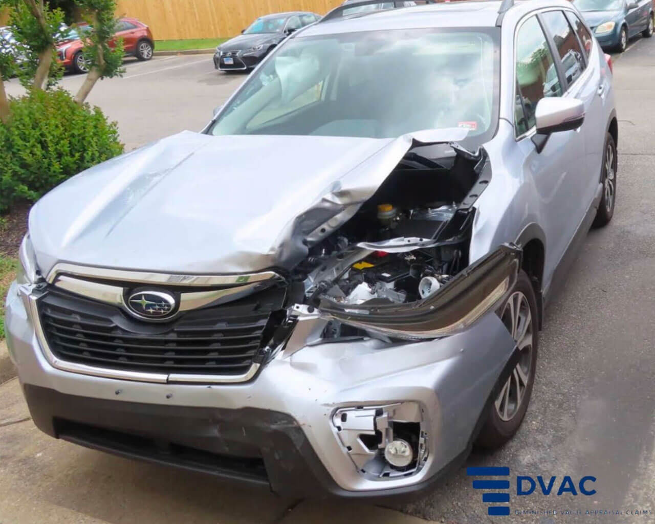 A silver subaru with a smashed in upper driver front side